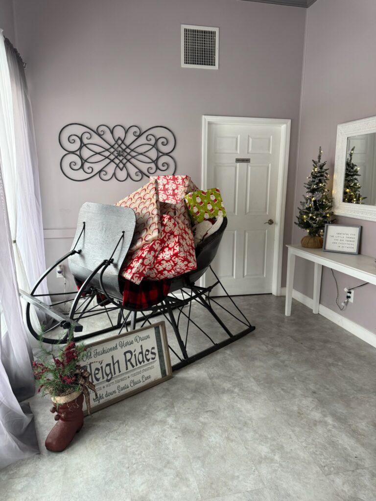 A warm, winter-themed photo opportunity inside Meks on Main featuring soft lighting and seasonal decor