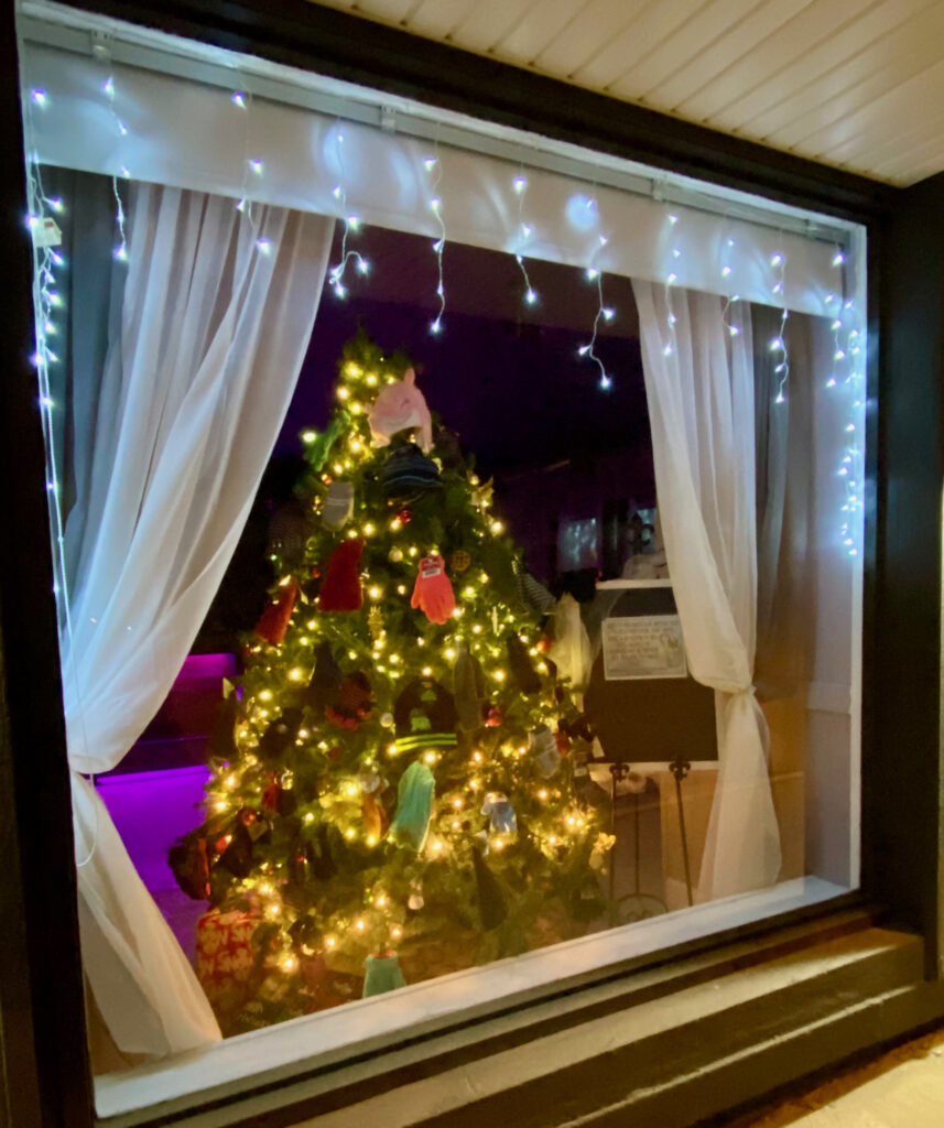 Exterior of Meks on Main in historic downtown Monmouth, Illinois during the holidays with warm seasonal lighting.